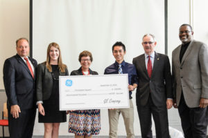 UW biomedical engineering undergraduate Chris Nguyen (center right) receives a GE Unimpossible Missions Award during a ceremony held in Engineering Hall at the University of Wisconsin-Madison on Sept. 12, 2016. Nguyen will receive a scholarship of up to $100,000 and a 10-week paid internship at the GE Global Research Center in Niskayuna, New York. (Photo by Bryce Richter / UW-Madison)