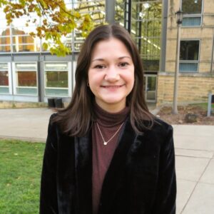 A photo of Bridget Cook, standing in front of UW Law School