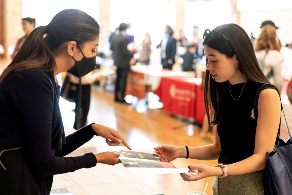 A Law School representative and a pre law student looking at a brochure